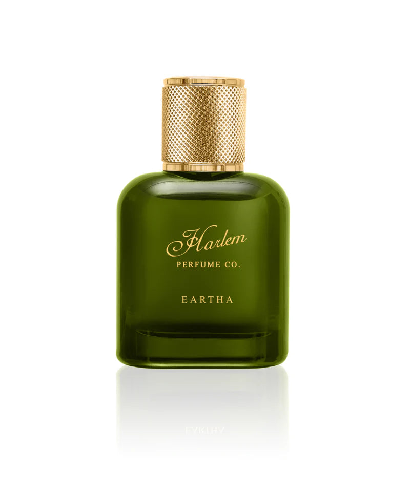 A green glass bottle of Simply Eartha's EARTHA EAU DE PARFUM with a textured gold cap, inspired by Eartha Kitt, is shown on a white background—a sensual fragrance in Eau de Parfum form.